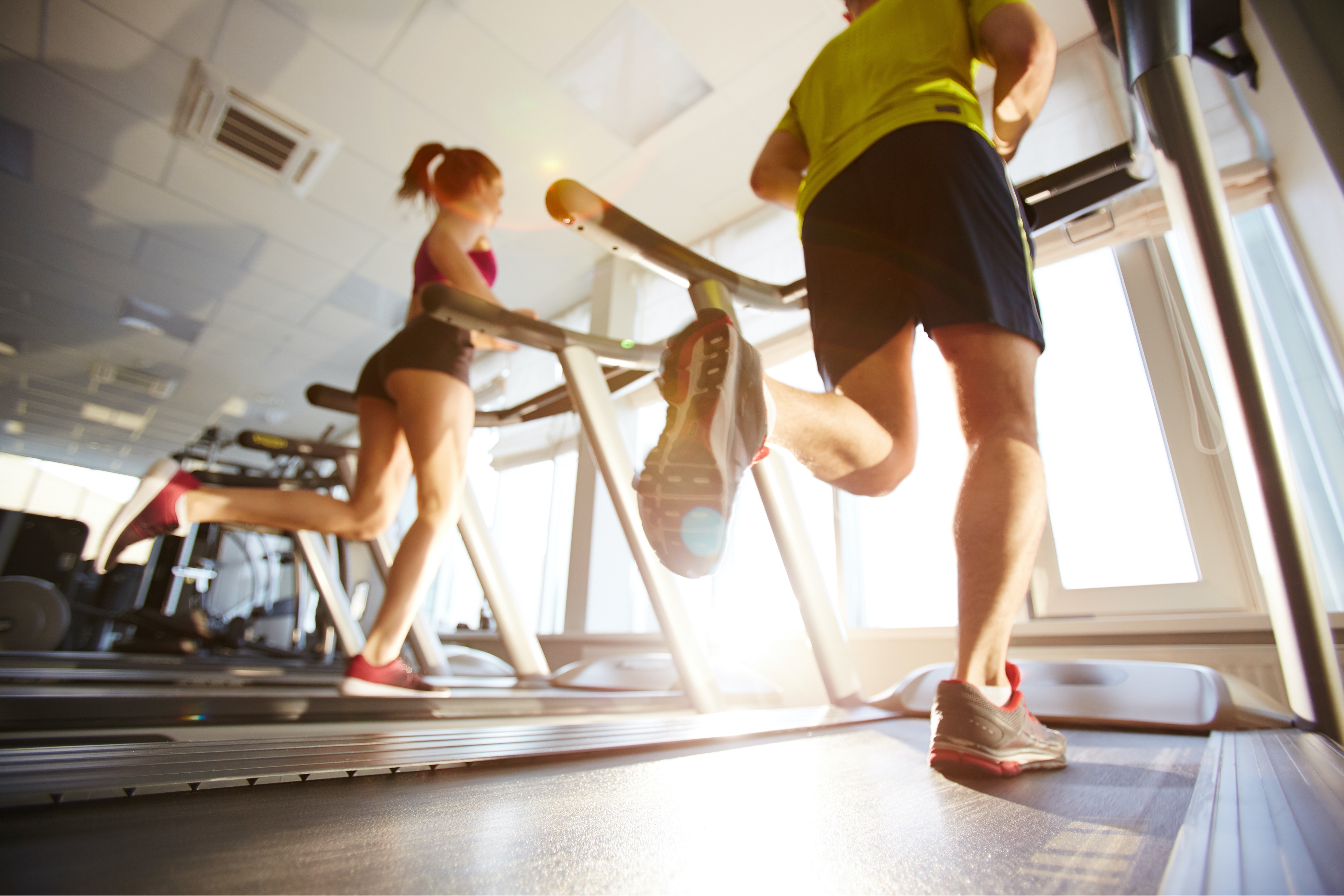 Young Couple Exercising on a Treadmill