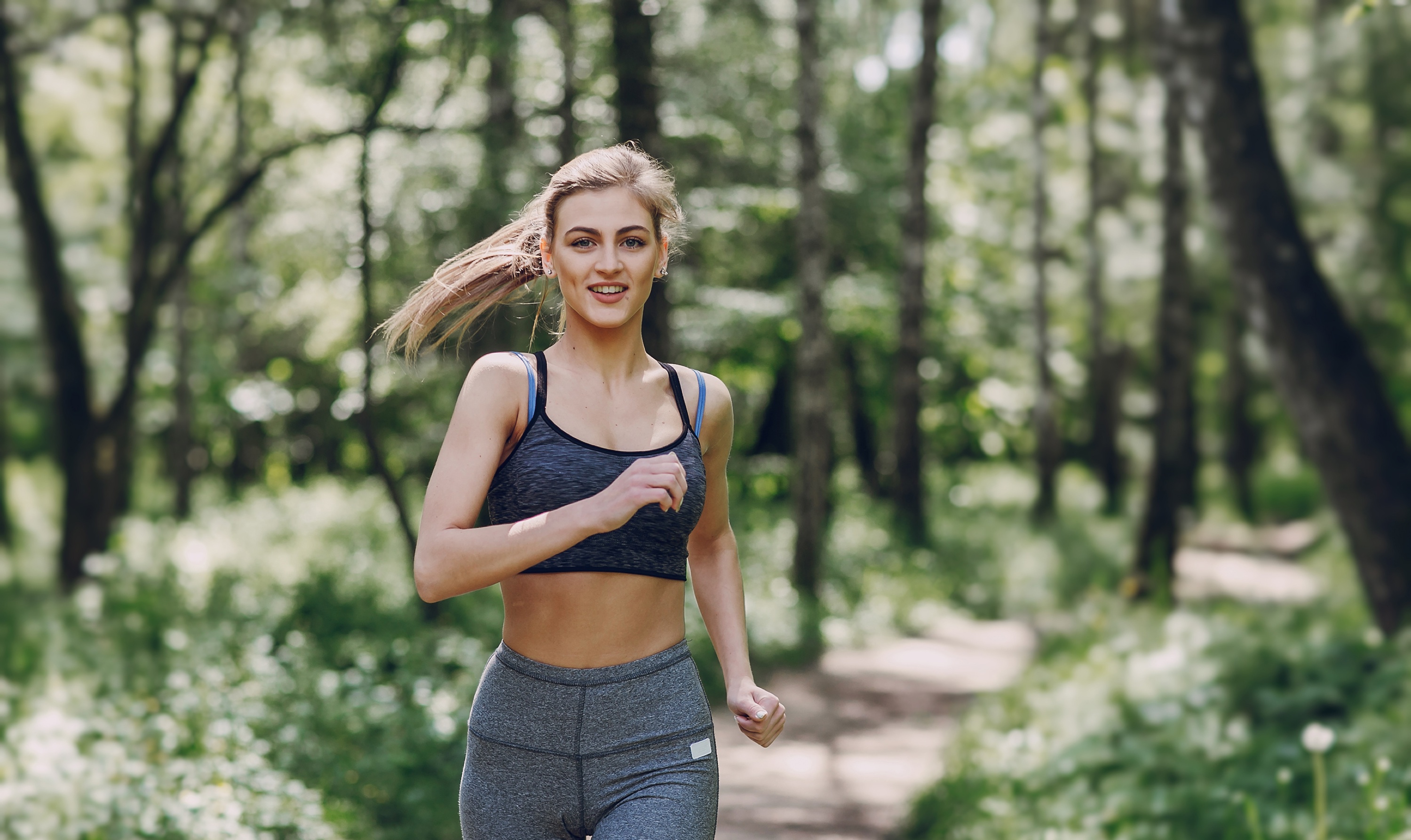 Young Woman Jogging in the Woods